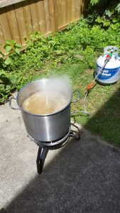 Home-brew beer boils on outdoor burner.