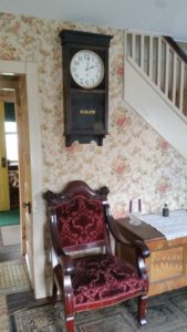 clock on wall above chair
