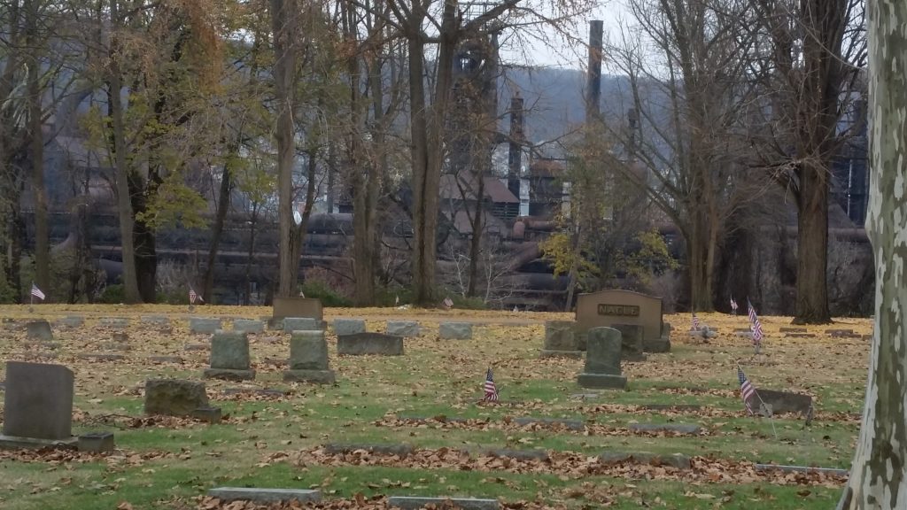 cemetery scene with industry in background