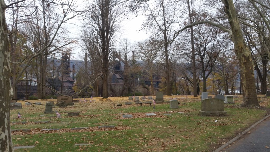 autumn cemetery scene with industry in background